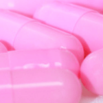 pink capsule pills on counter