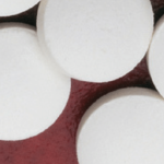 white round pills on red background