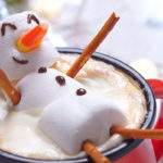 A marshmallow man in a cup of hot chocolate
